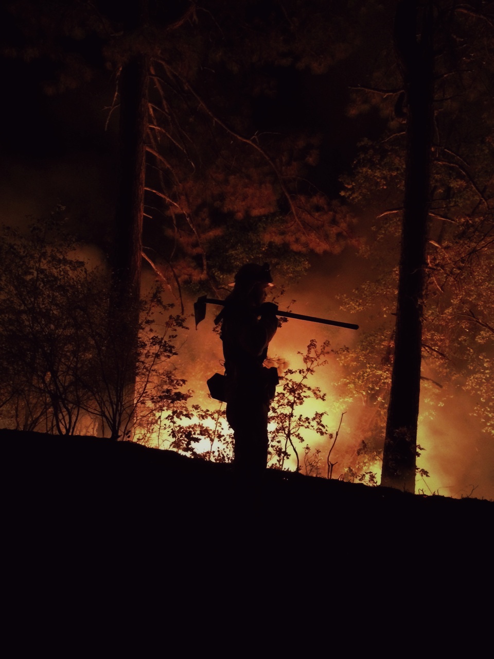 firefighter holding tool on shoulder